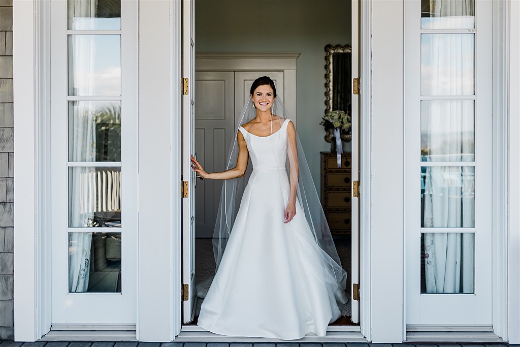 Bride stands in a doorway