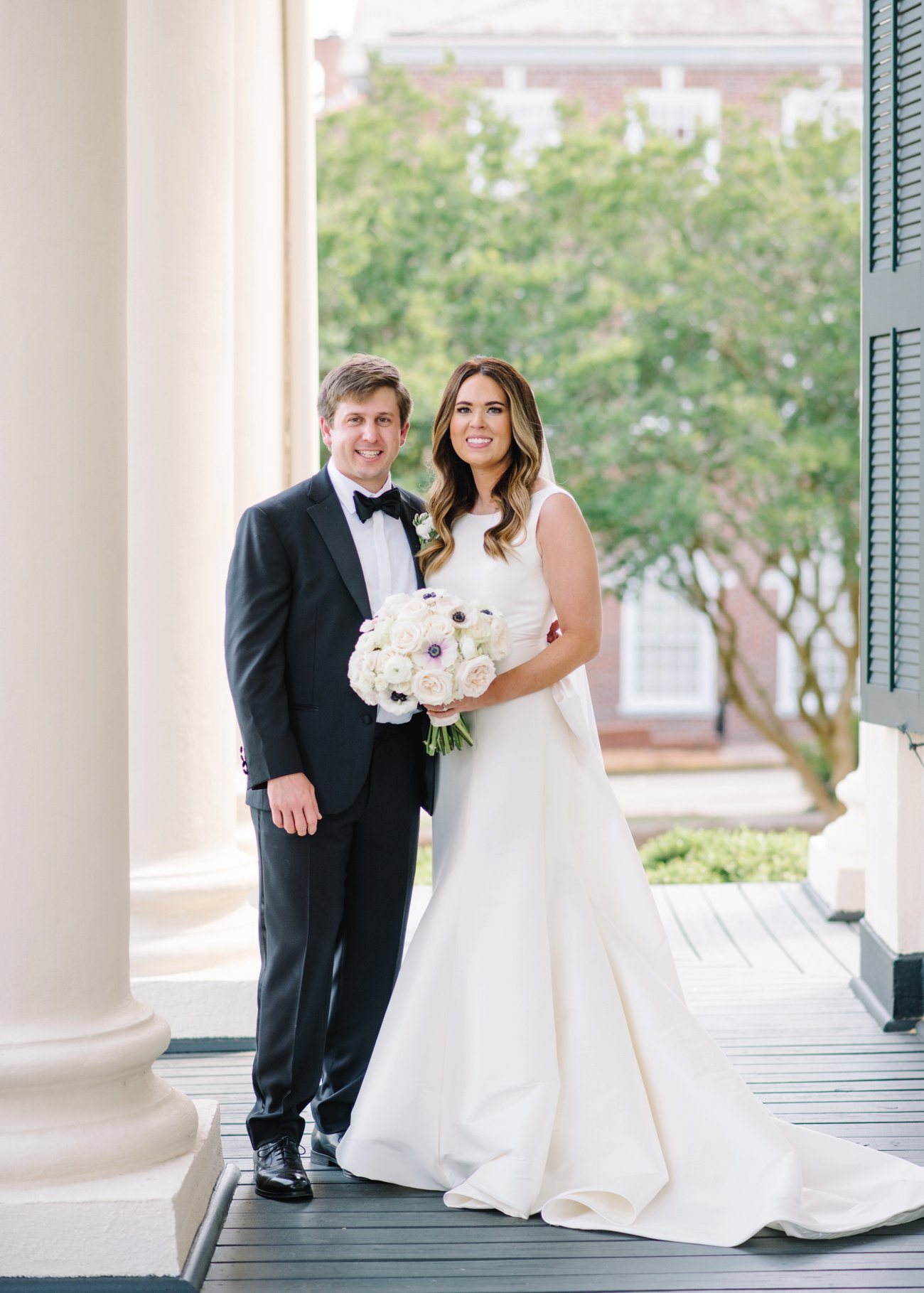 Bride and groom on grand southern porch