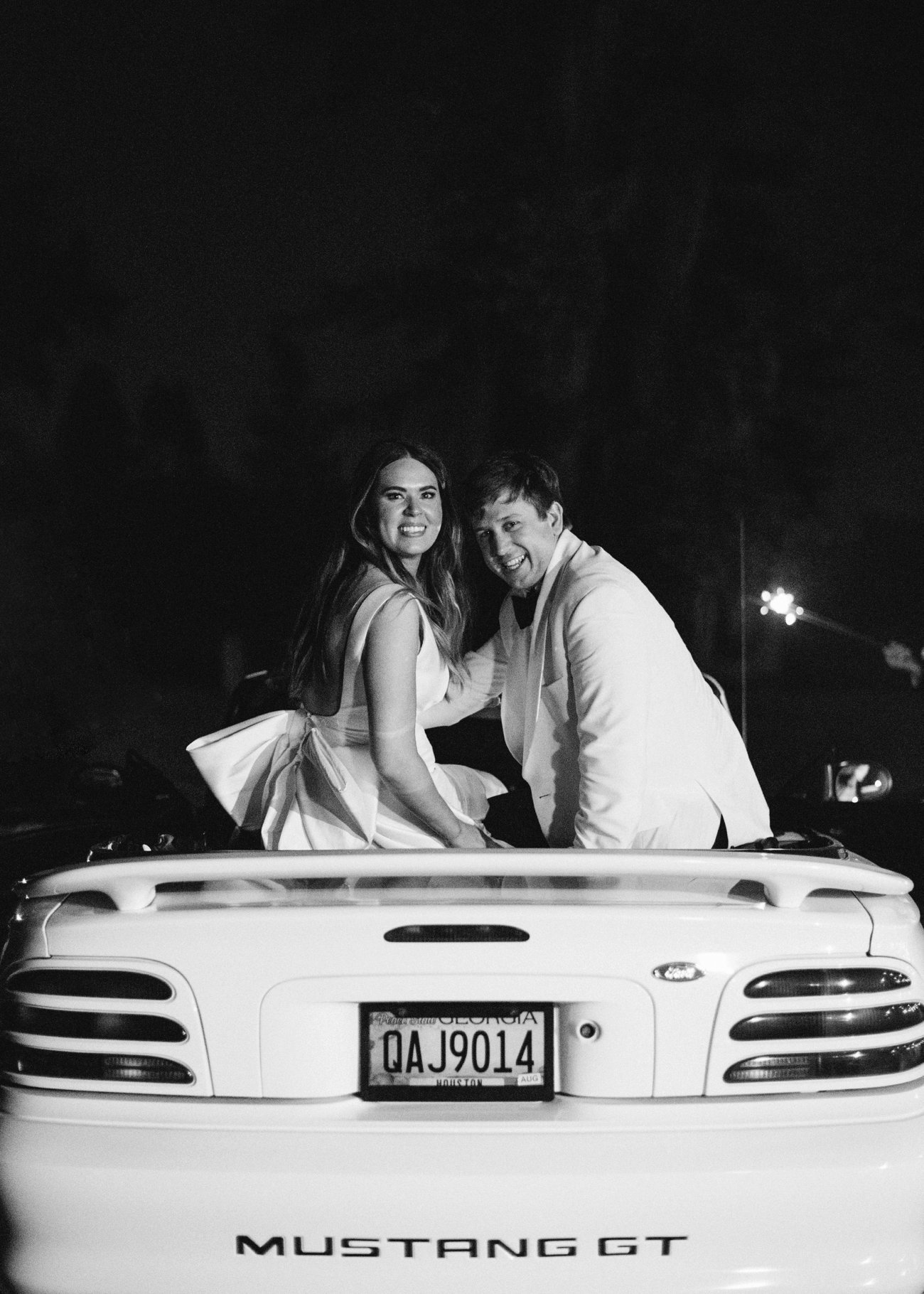 Bride and groom wedding getaway car