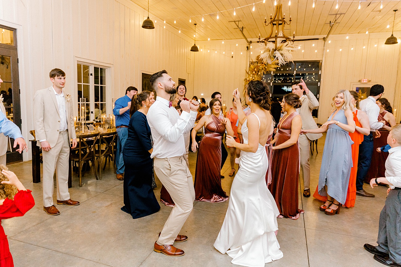 Bride and groom dancing during fun reception