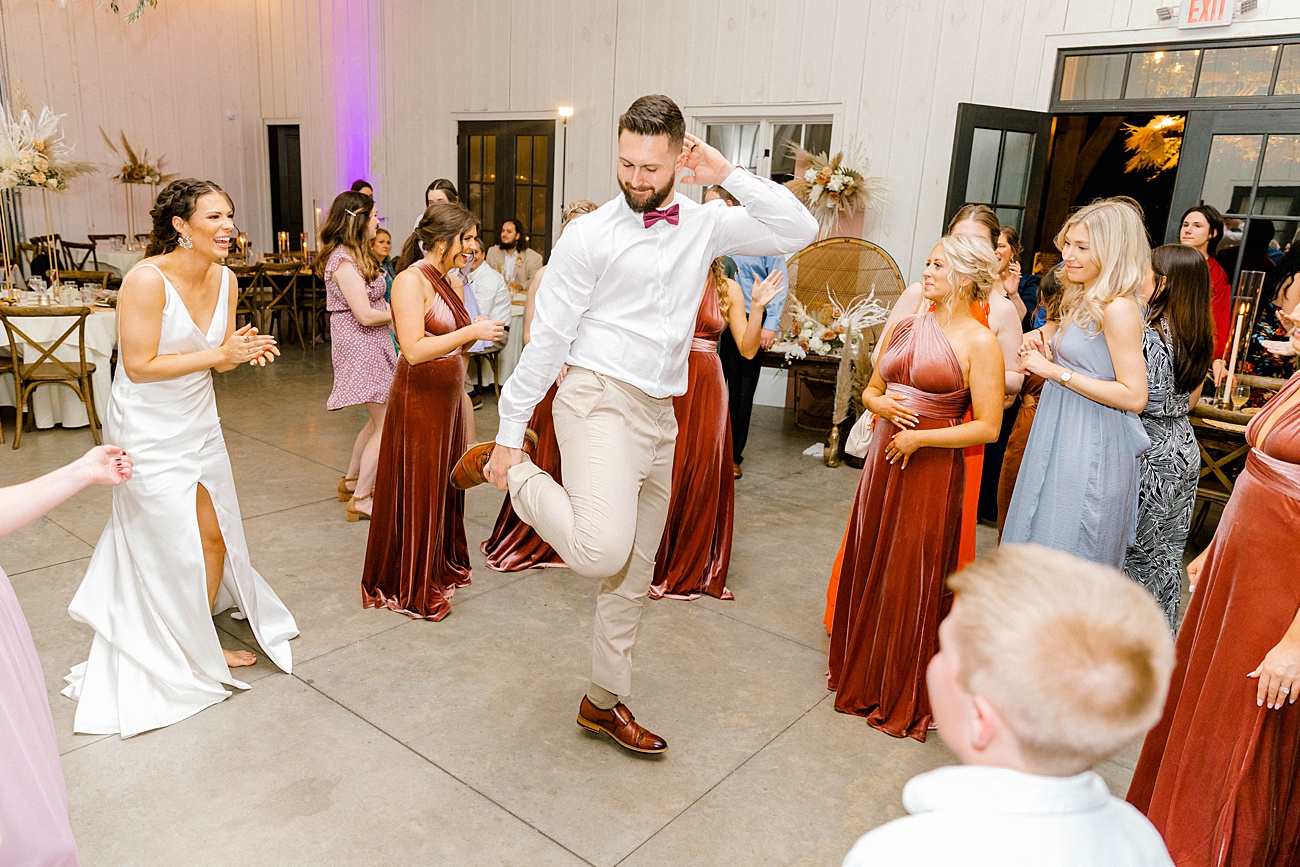 Bride and groom dancing during fun reception