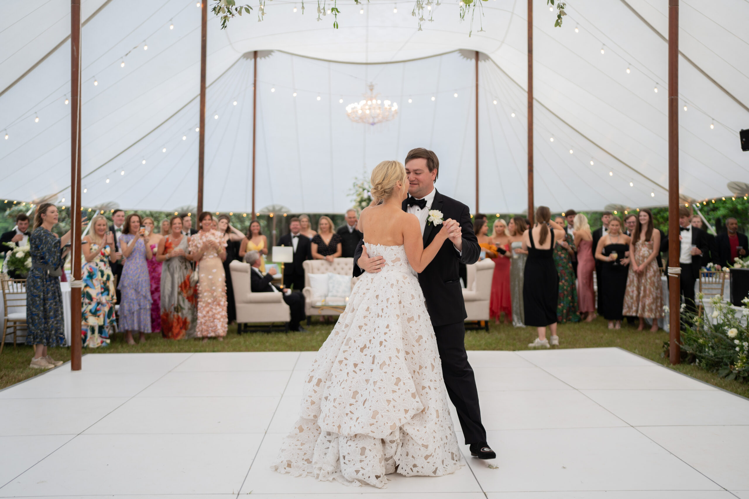 bride and groom first dance on dance florr at tented wedding reception